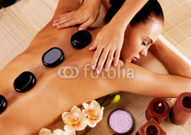 Adult_woman_having_hot_stone_massage_in_spa_salon.jpg